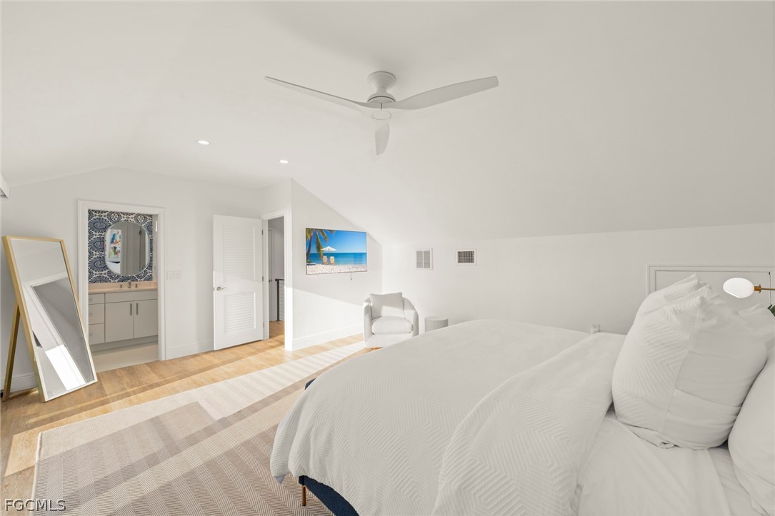 19 Beach Homes Captiva, FL 33924 - Photo 38 of 49 a bedroom with a bed and a large mirror