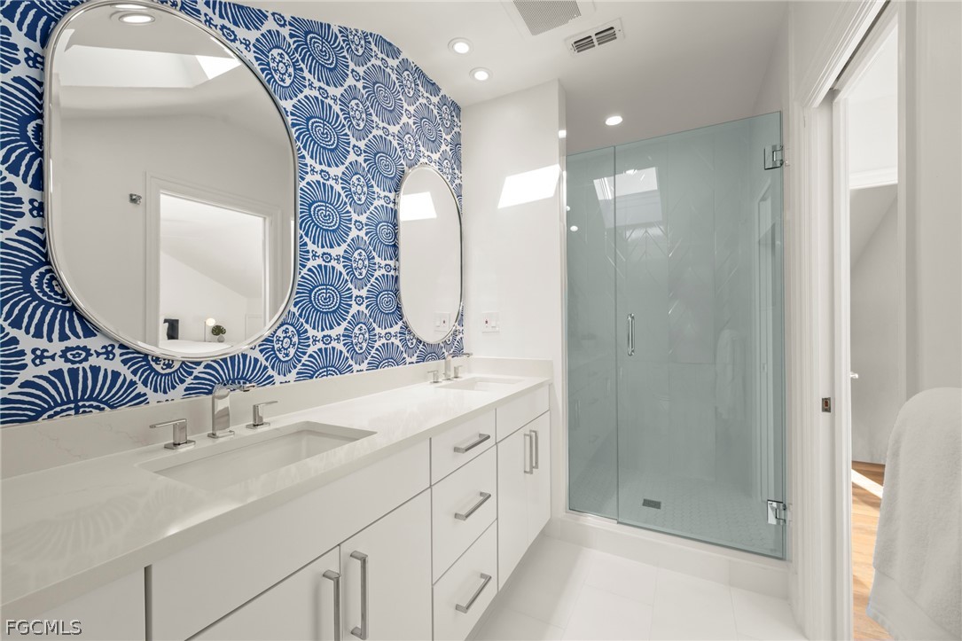 19 Beach Homes Captiva, FL 33924 - Photo 39 of 49 a bathroom with a double vanity sink mirror and shower