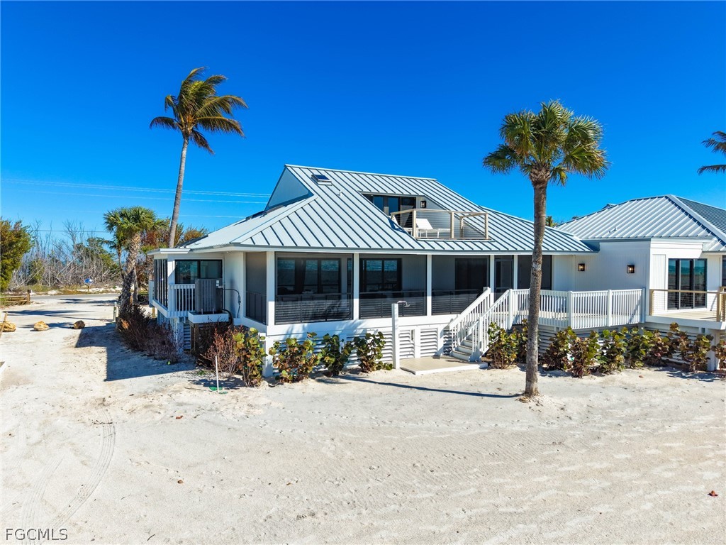 19 Beach Homes Captiva, FL 33924 - Photo 42 of 49 a front view of a house with a yard and potted plants