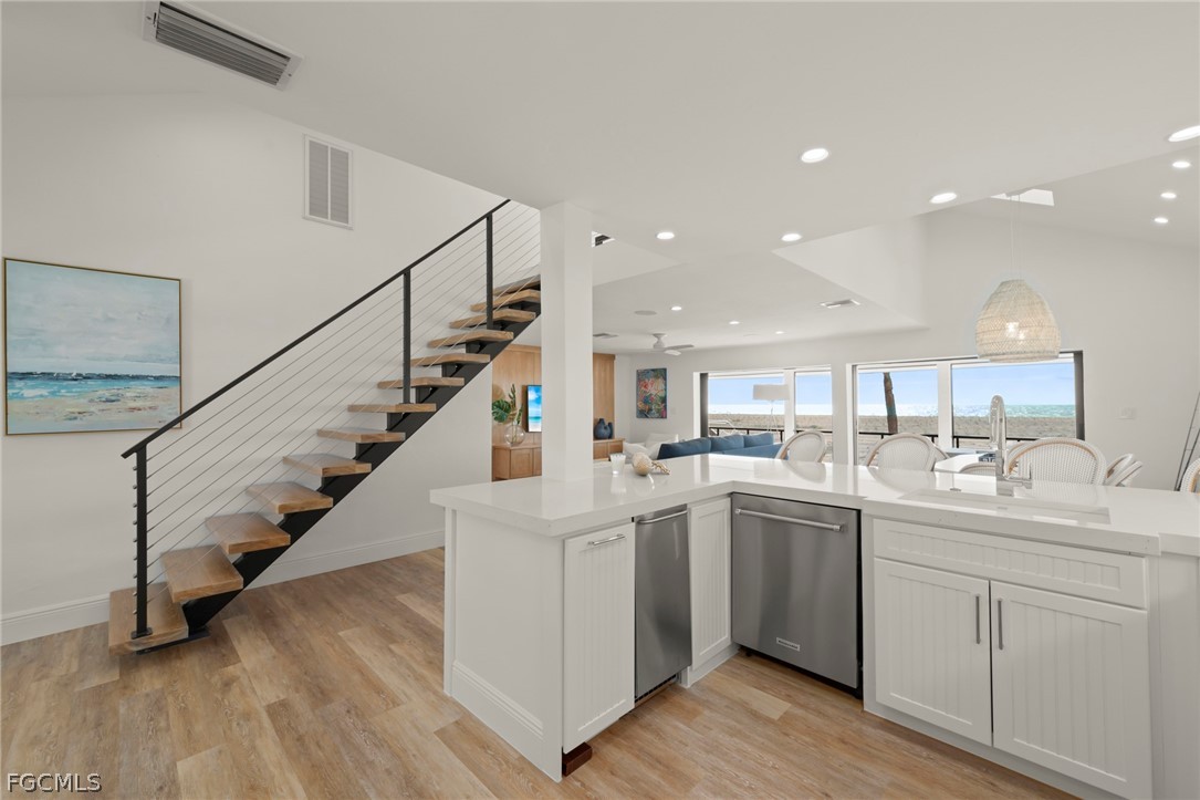 19 Beach Homes Captiva, FL 33924 - Photo 8 of 49 a kitchen with white cabinets sink and white appliances