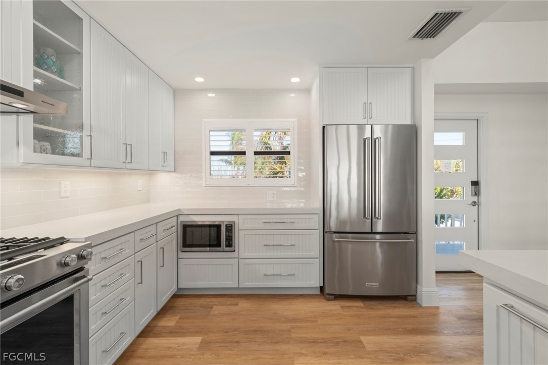 19 Beach Homes Captiva, FL 33924 - Photo 9 of 49 a kitchen with a refrigerator cabinets and wooden floor