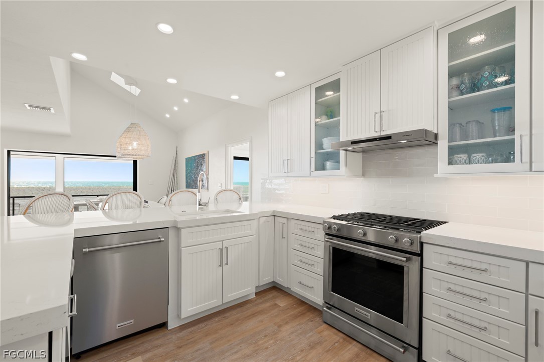 19 Beach Homes Captiva, FL 33924 - Photo 10 of 49 a kitchen with stainless steel appliances granite countertop a sink and stove top oven