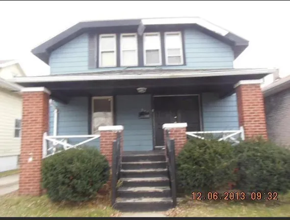 a front view of a house with stairs