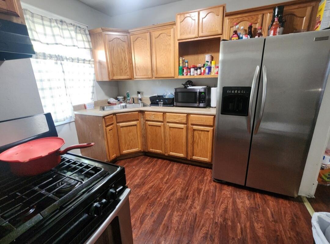 824 Merrill Street Hammond, IN 46320 - Photo 2 of 5 a kitchen with stainless steel appliances granite countertop a refrigerator stove and sink