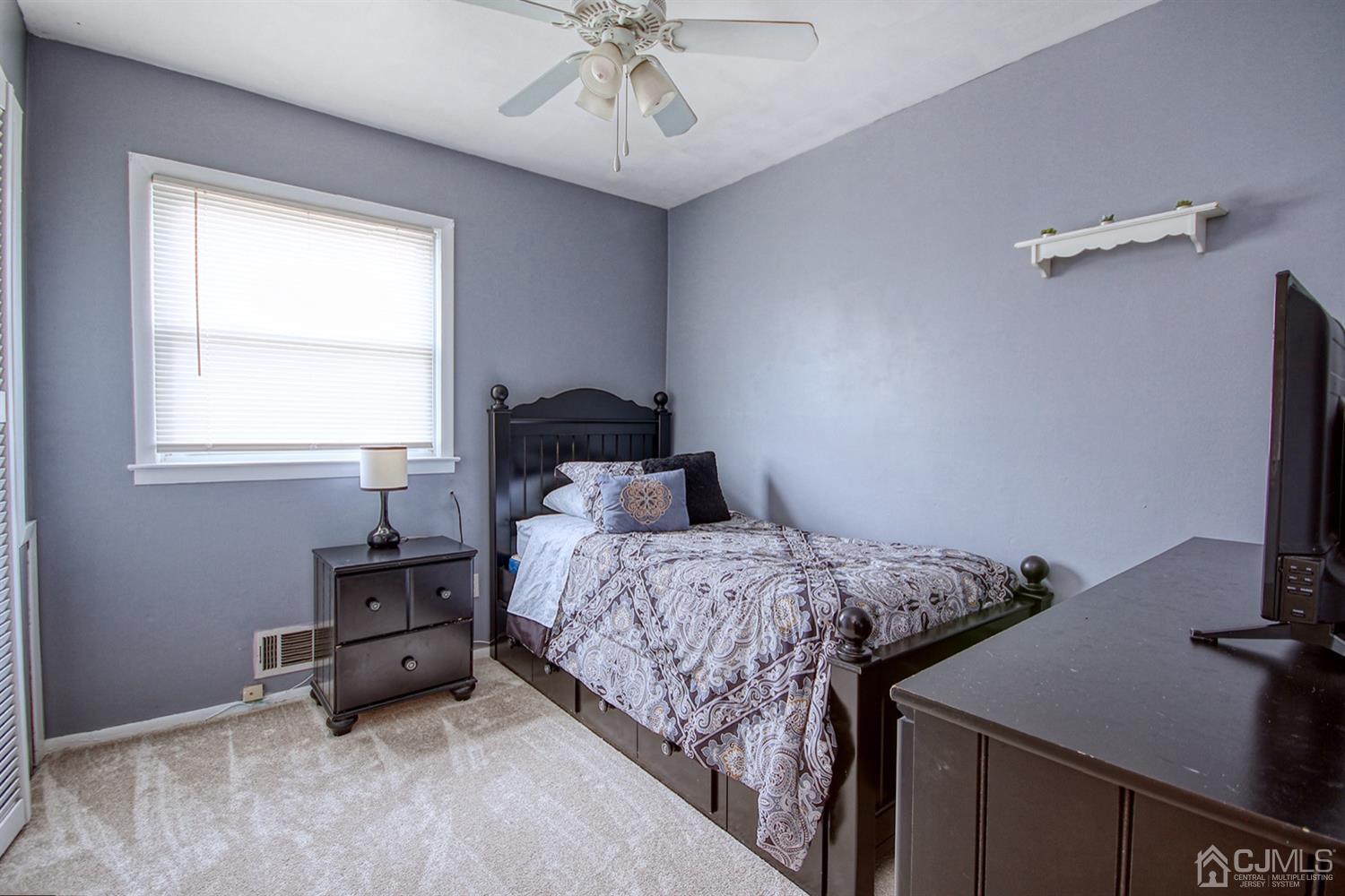 19 Sulliman Road Edison, NJ 08817 - Photo 17 of 22 a bedroom with a bed and a chandelier