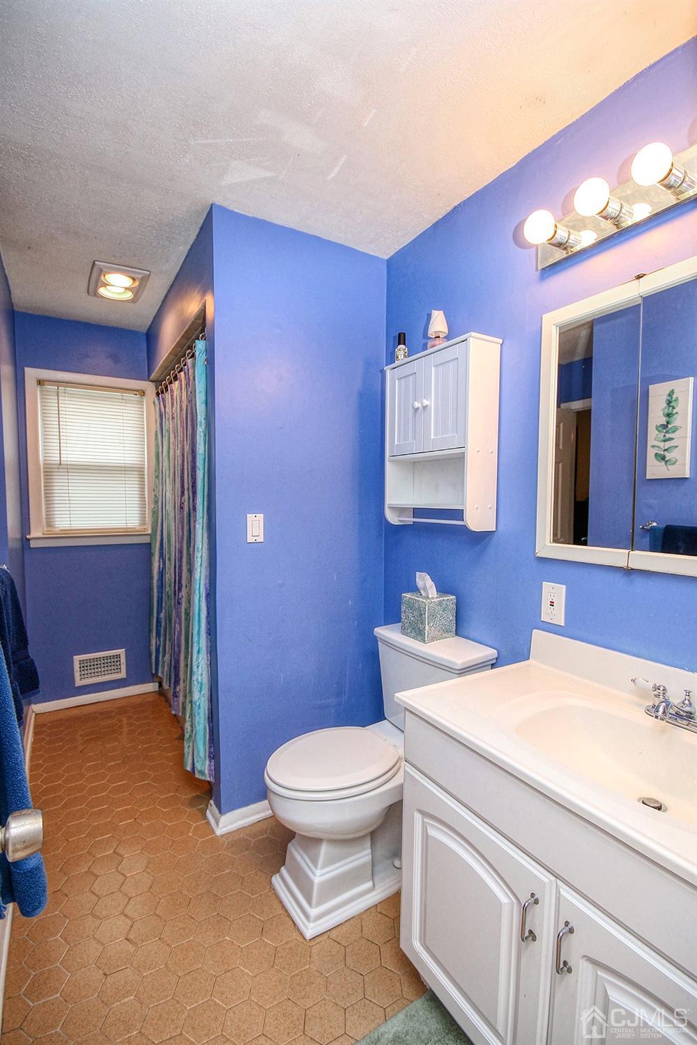 19 Sulliman Road Edison, NJ 08817 - Photo 18 of 22 a bathroom with a sink a toilet and mirror