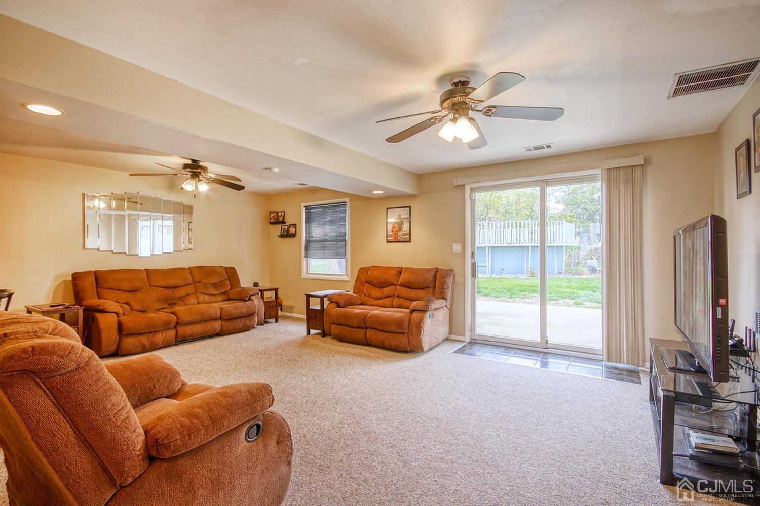 19 Sulliman Road Edison, NJ 08817 - Photo 5 of 22 a living room with furniture and a flat screen tv