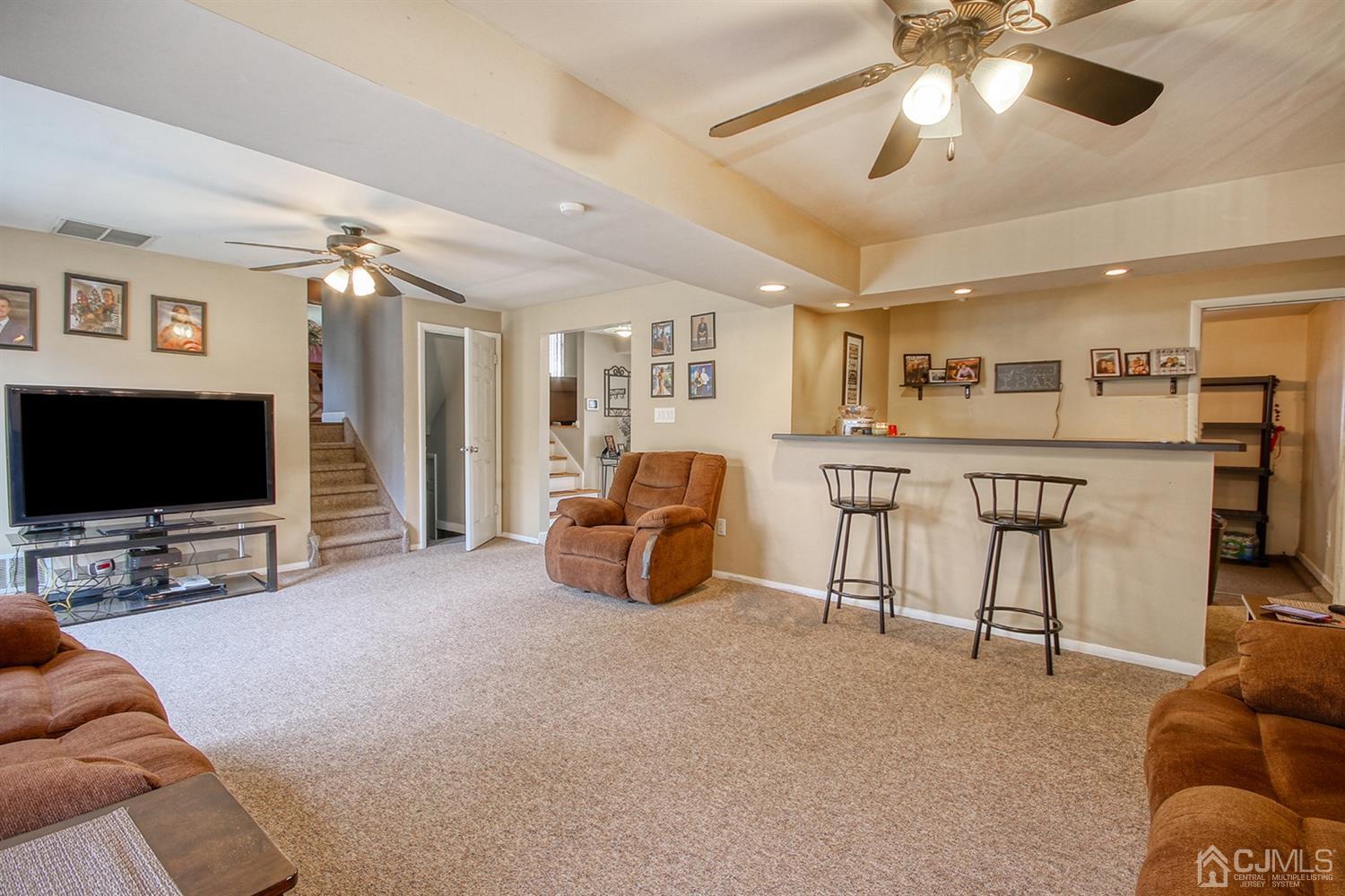 19 Sulliman Road Edison, NJ 08817 - Photo 6 of 22 a living room with furniture and a flat screen tv