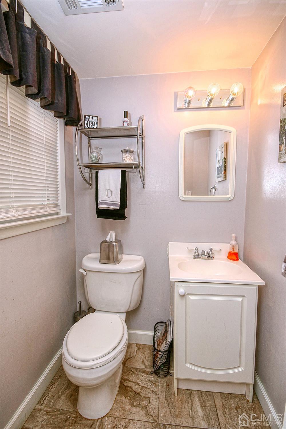 19 Sulliman Road Edison, NJ 08817 - Photo 9 of 22 a bathroom with a toilet sink and mirror