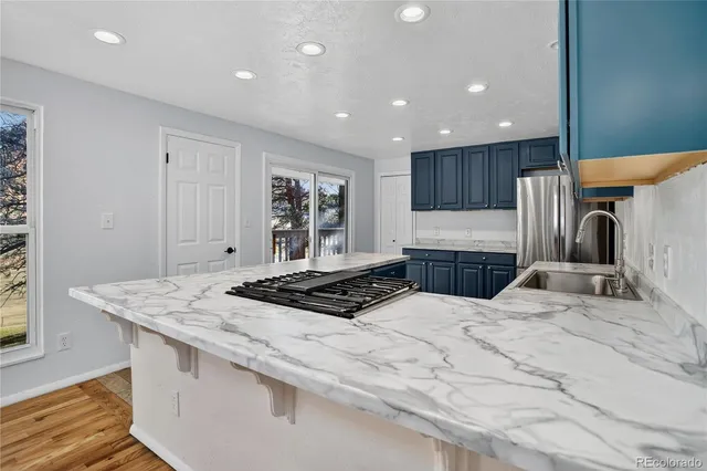 a kitchen with a stove a sink and a refrigerator