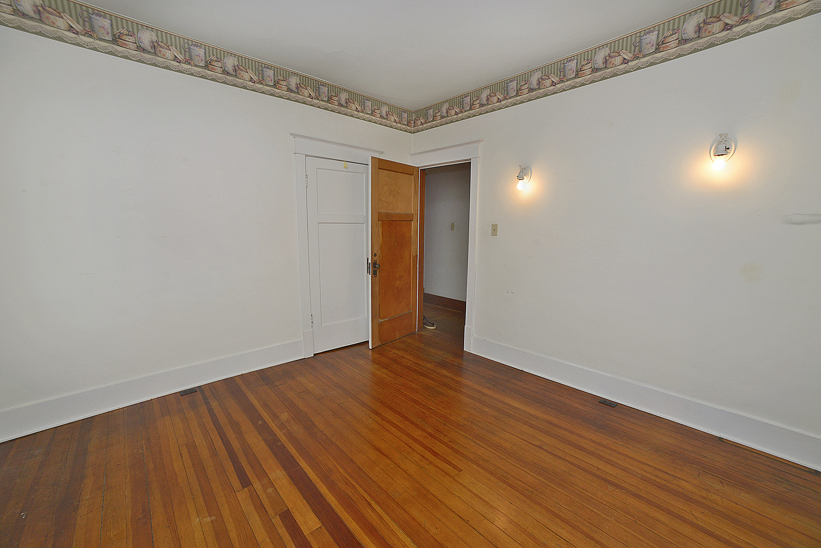 221 East Grove Street Utica, IL 61373 - Photo 11 of 27 a view of an empty room with wooden floor