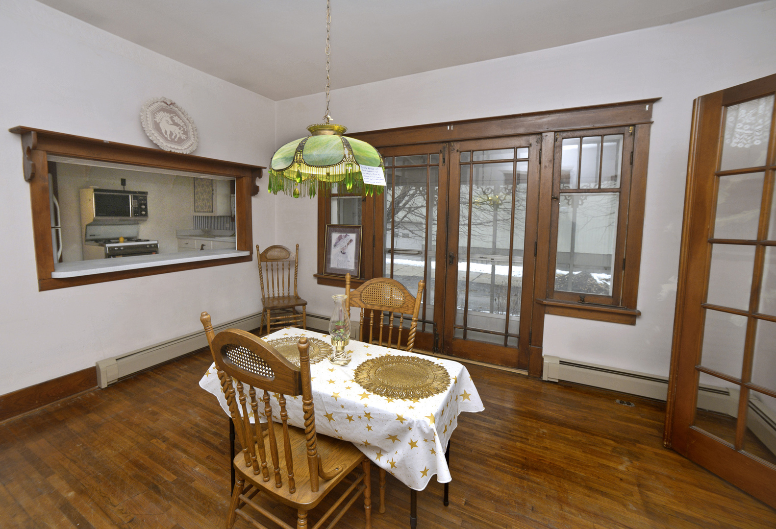 221 East Grove Street Utica, IL 61373 - Photo 6 of 27 a dining room with furniture a chandelier and wooden floor