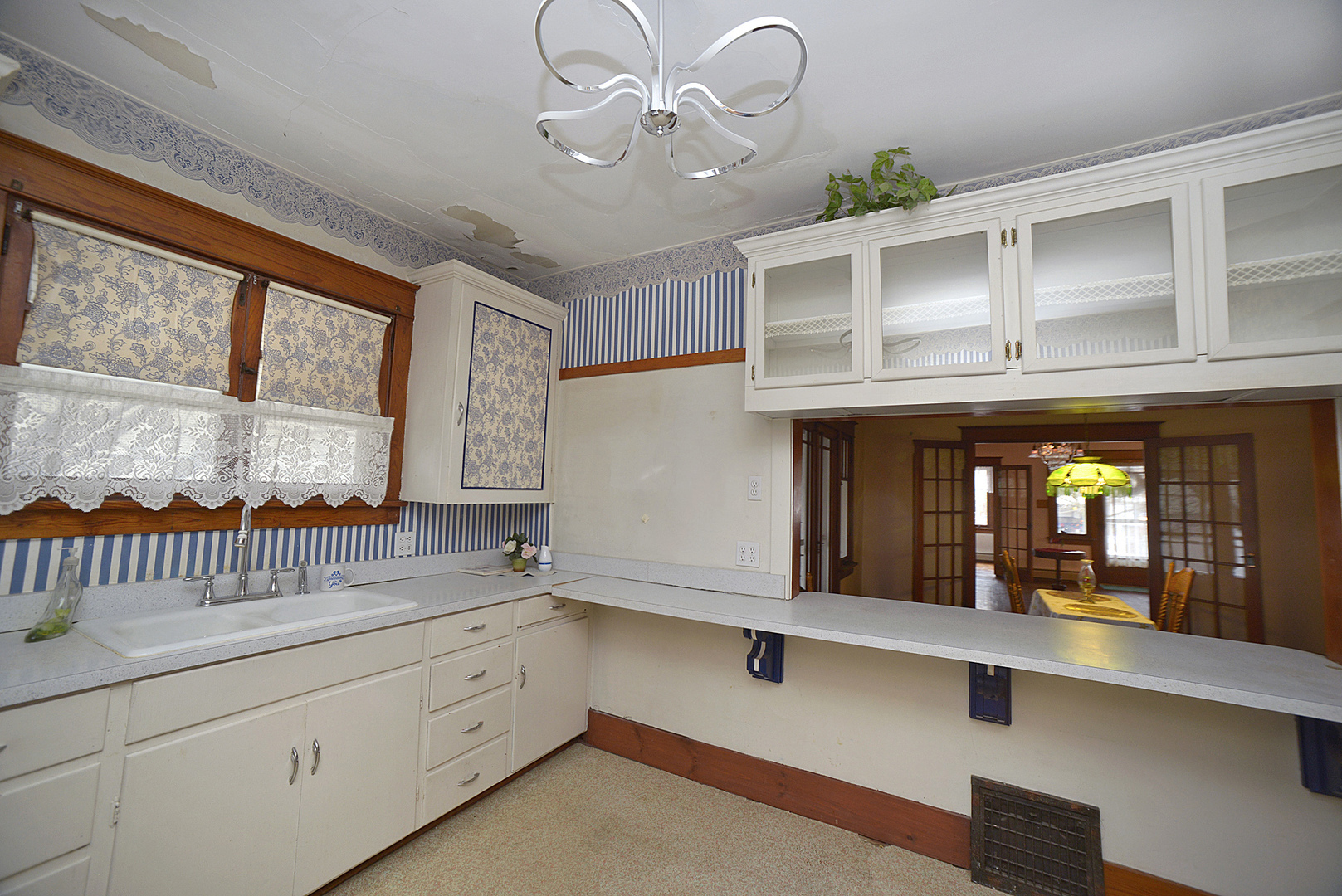 221 East Grove Street Utica, IL 61373 - Photo 7 of 27 a kitchen with sink cabinets and window