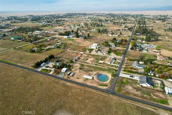 an aerial view of a residential houses with city view
