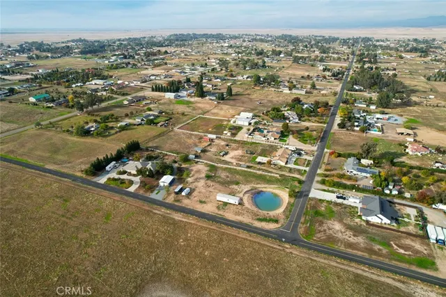 an aerial view of a residential houses with city view