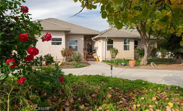an empty room with wooden floor a chandelier a wooden table and chairs