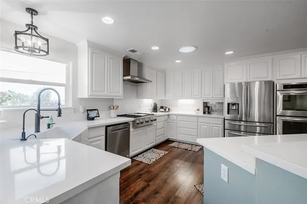 a kitchen with lots of clutter and cabinets