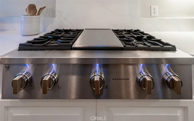 a bedroom with a bed and a flat tv screen on dresser
