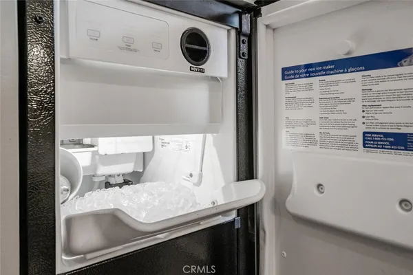 a bedroom with a bed and a flat tv screen on dresser