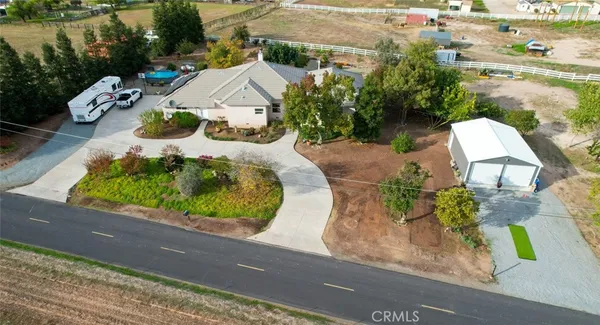 an aerial view of a house with a yard and lake view