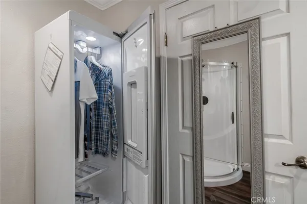 a view of a balcony with wooden chairs and floor to ceiling window