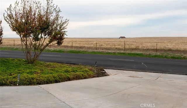 a view of a chairs and tables in the back yard of the house