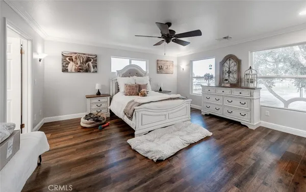 a view of a patio with table and chairs potted plants and a barbeque