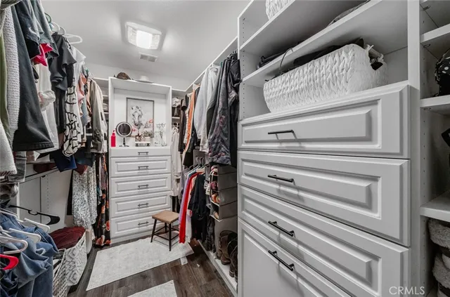 a view of a patio with table and chairs potted plants and a barbeque