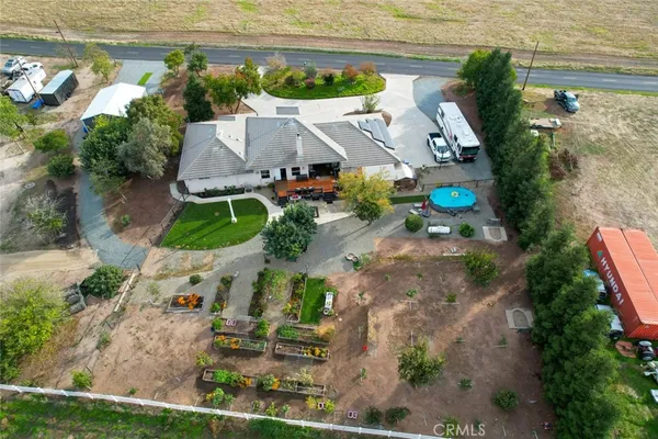 an aerial view of a house with a yard