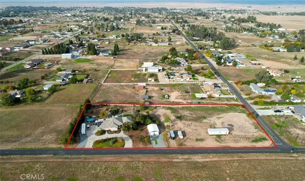 an aerial view of a residential houses with outdoor space