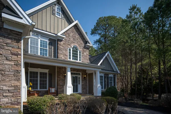 a kitchen with stainless steel appliances a refrigerator a sink dishwasher a stove and white cabinets with wooden floor
