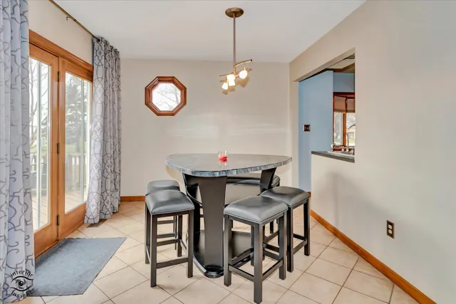 a dining room with furniture a chandelier and window