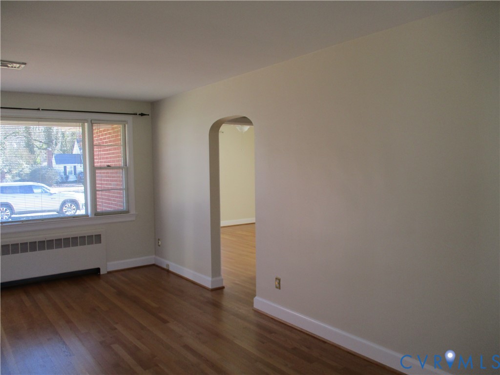 1310 Forest Avenue Henrico, VA 23229 - Photo 2 of 6 an empty room with wooden floor and windows