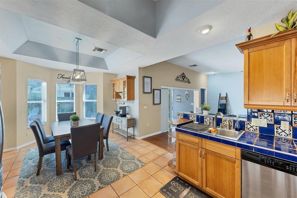 7192 North Paragon Road North Port, FL 34291 - Photo 11 of 40 a large kitchen with a table and chairs