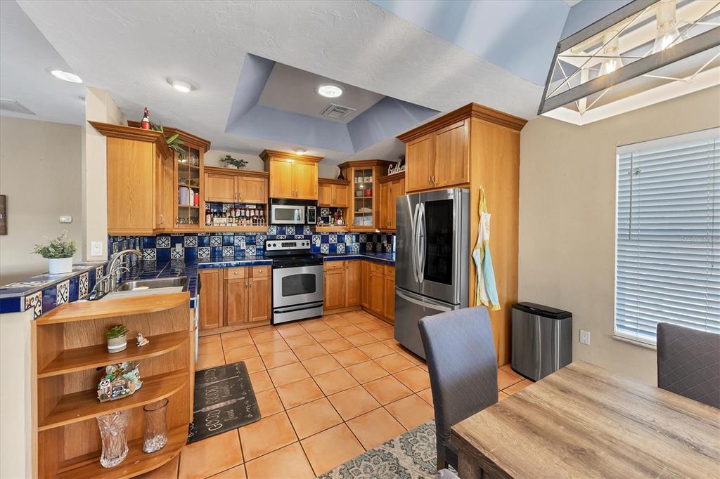 7192 North Paragon Road North Port, FL 34291 - Photo 12 of 40 a kitchen with stainless steel appliances wooden floor dining table and chairs