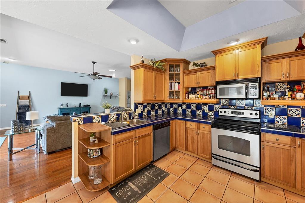 7192 North Paragon Road North Port, FL 34291 - Photo 10 of 40 a kitchen with stainless steel appliances granite countertop a sink stove and microwave