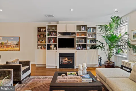 a living room with furniture fireplace and rug