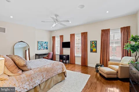 a bedroom with a bed couch and a window