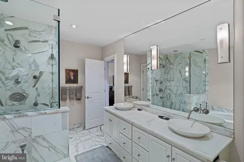 a bathroom with a granite countertop sink mirror and shower