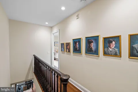 a view of a hallway with paintings on the wall