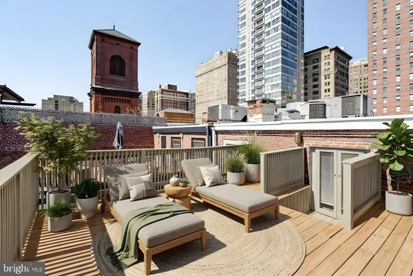 an aerial view of a balcony with chairs and city view