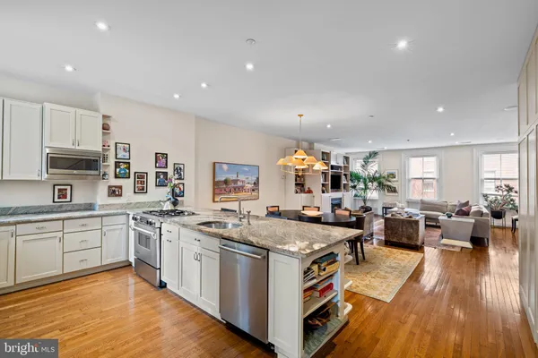 a kitchen with stainless steel appliances granite countertop a stove and cabinets
