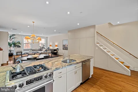 a kitchen with stove and a refrigerator