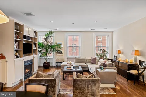 a living room with furniture fireplace and flat screen tv