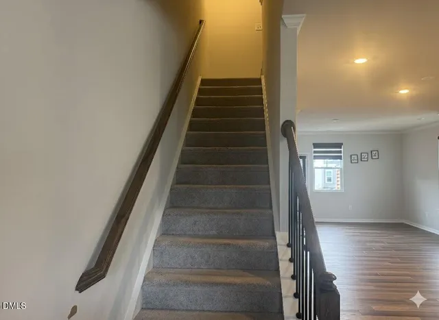 a view of entryway and hall with wooden floor