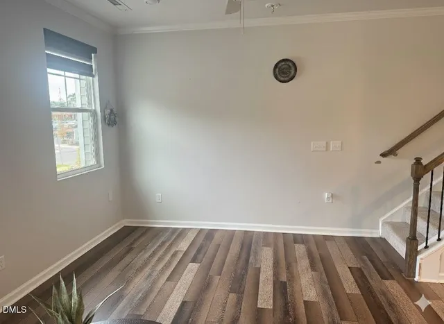a view of a room with wooden floor and a window