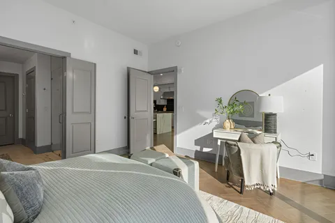 a bedroom with furniture and a wooden floor