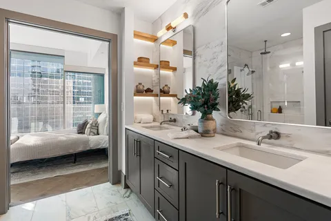 a en suite bathroom with a sink double vanity and a tub