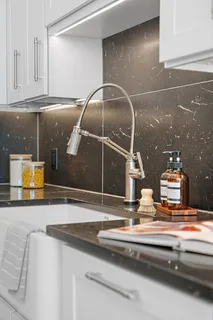 a kitchen with a sink and a mirror