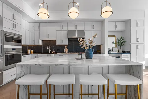a kitchen with a table chairs stove and cabinets
